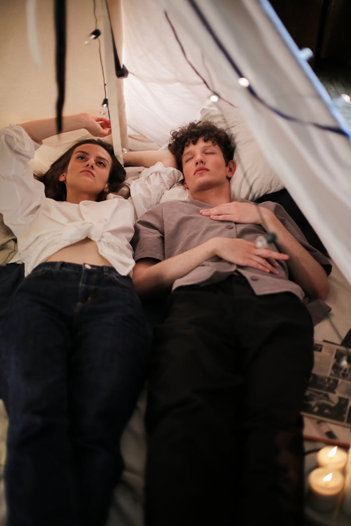 about-us-02 A young couple enjoys a peaceful moment in a cozy indoor tent setting.